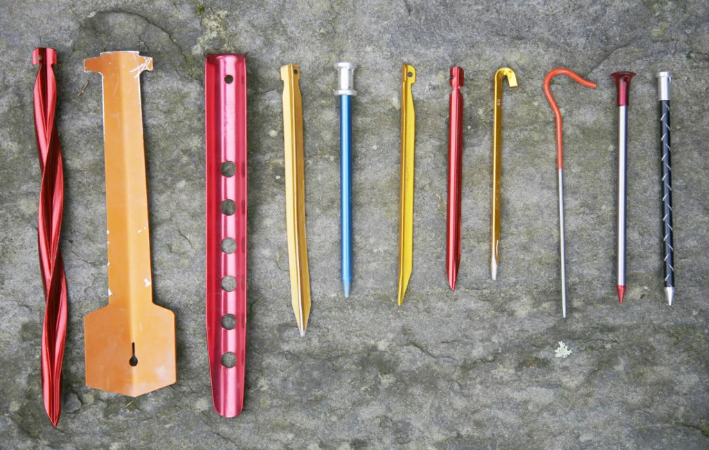 Tent stakes,: MSR Cyclone (35g),Toughstake (33g), MSR Snowstake (22g), DAC Y (14g), Easton Nano Nail (9g), DAC V (11g), MSR Mini Groundhog (9g), Hilleberg Tri-peg (8g), Vargo 6.5", Titanium (8g), MSR Carbon Core (5.5g), Easton Full Metal Jacket (5.5g). Image source: https://www.outdoorgearlab.com/topics/camping-and-hiking/best-backpacking-tent/buying-advice